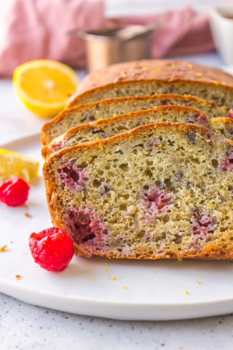 sliced raspberry lemon loaf on a white plate