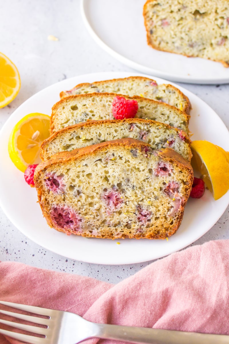 slices of raspberry lemon loaf on a plate