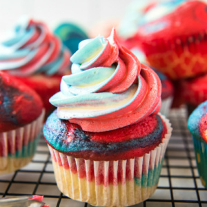 red white and blue cupcakes on a cooling rack