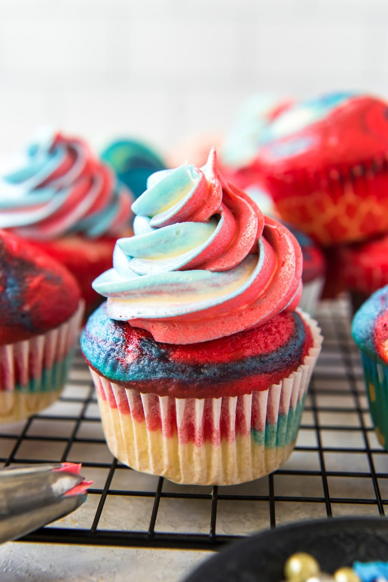 red white and blue cupcakes on a cooling rack
