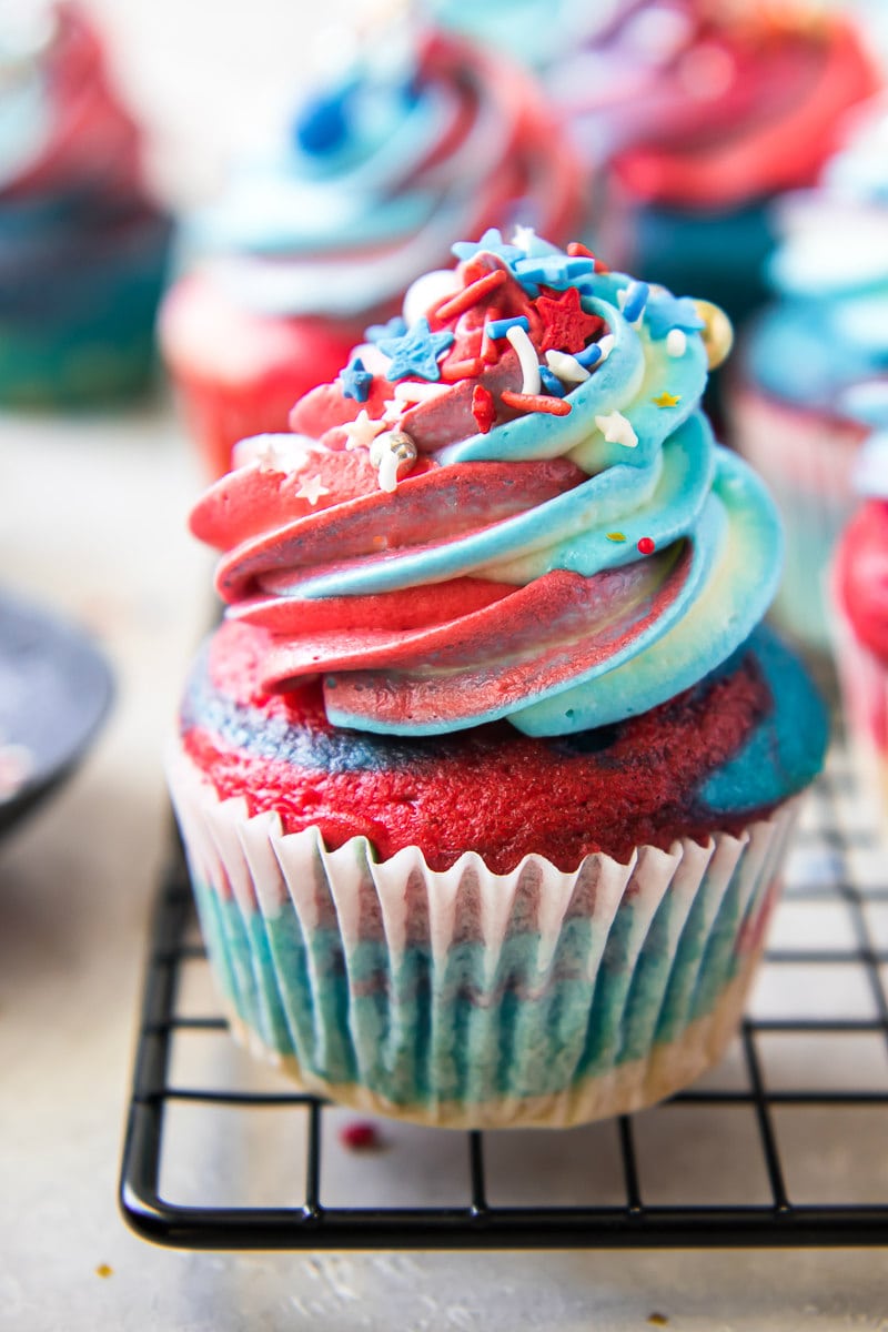 red white and blue cupcakes on a cooling rack