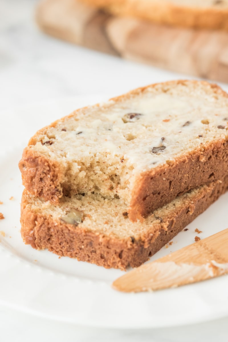 two slices sour cream maple bread stacked and with a bite out of it