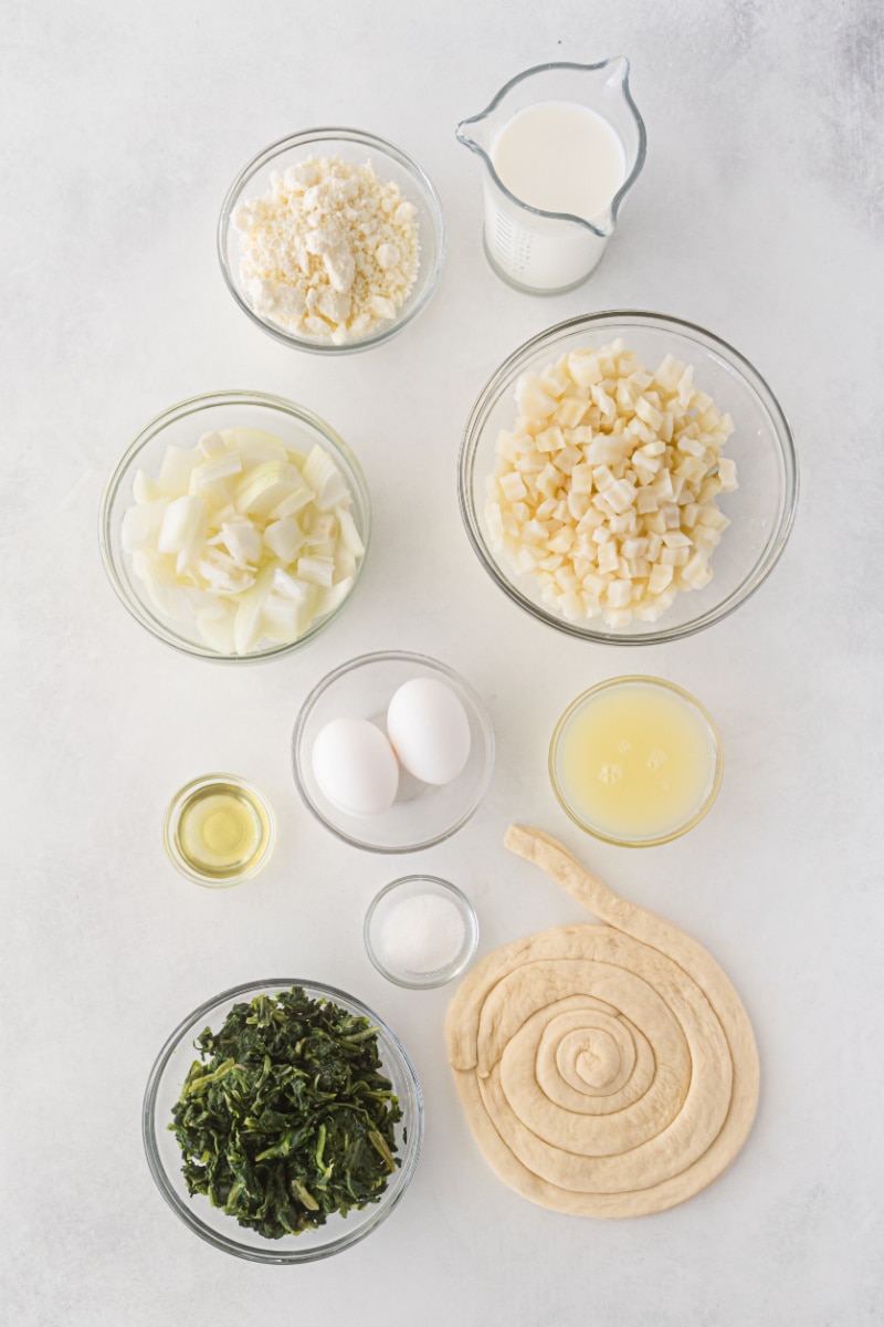 ingredients displayed for making spinach, caramelized onion and feta quiche