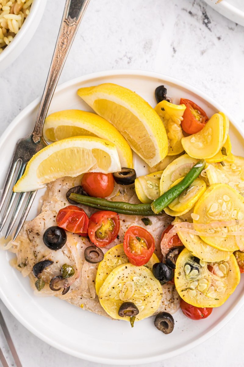 tilapia and veggie grill packets dumped on a plate