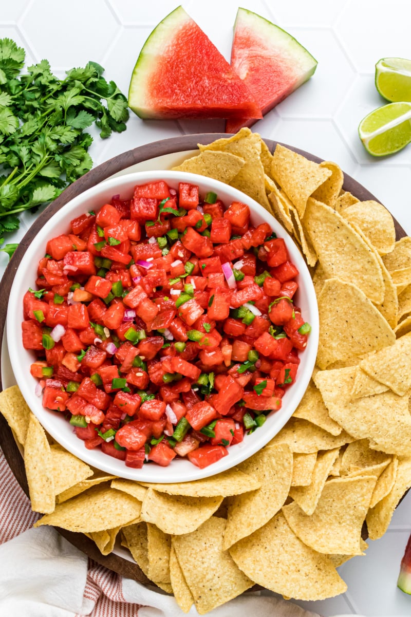 bowl of watermelon salsa with chips surrounding