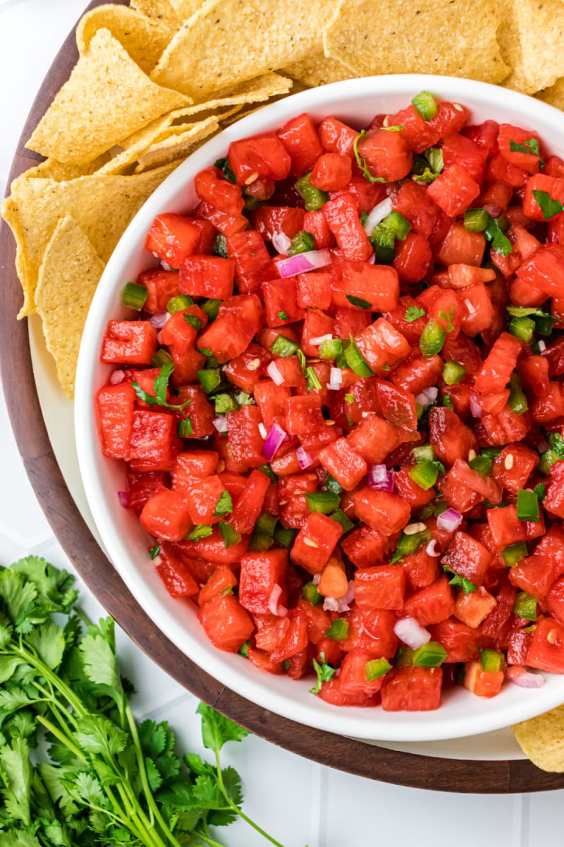 bowl of watermelon salsa with chips surrounding