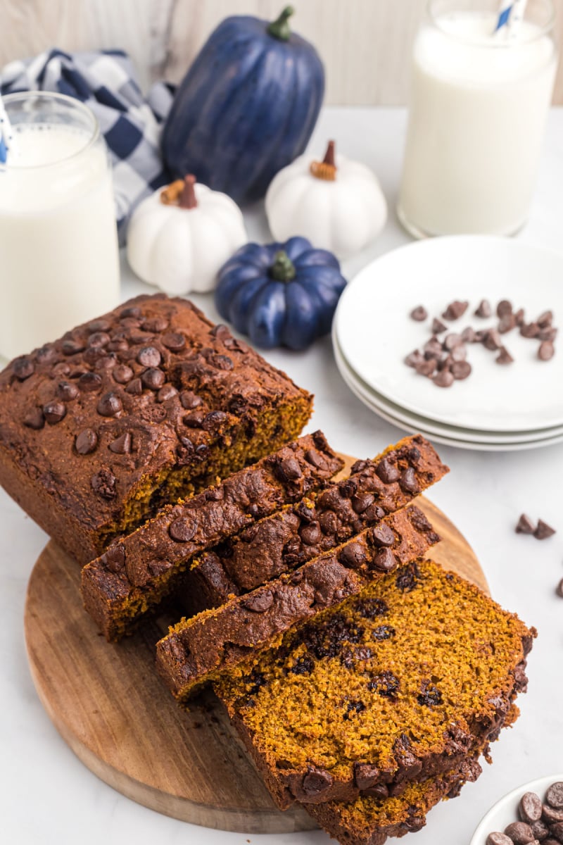 loaf of whole wheat chocolate chip pumpkin bread on board and sliced