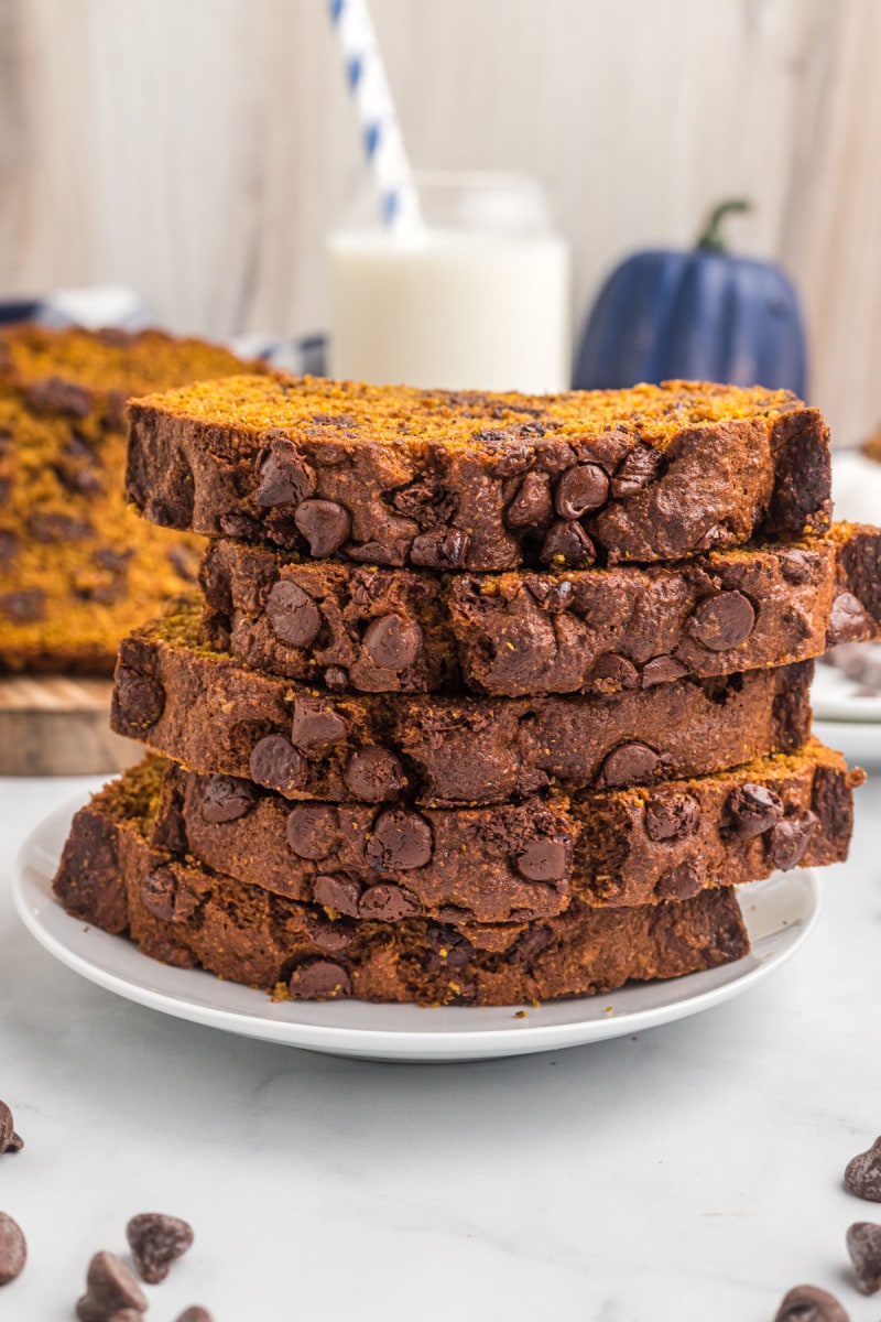 five slices of whole wheat chocolate chip pumpkin bread stacked on plate