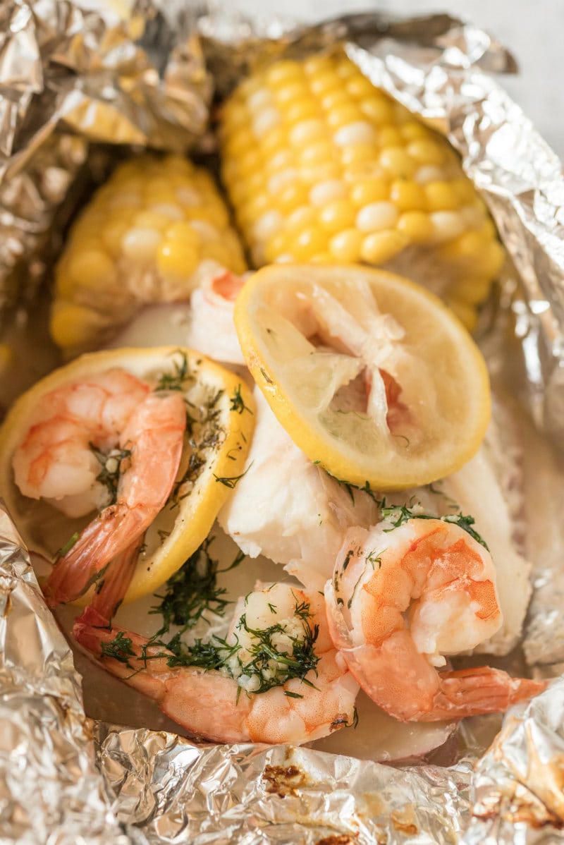 close up of grilled new england seafood foil packets opened up to see the inside