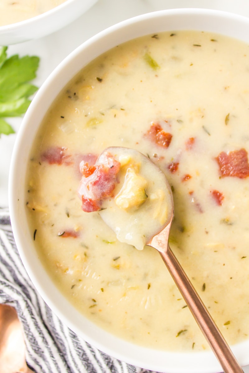 spooning out clam chowder from bowl