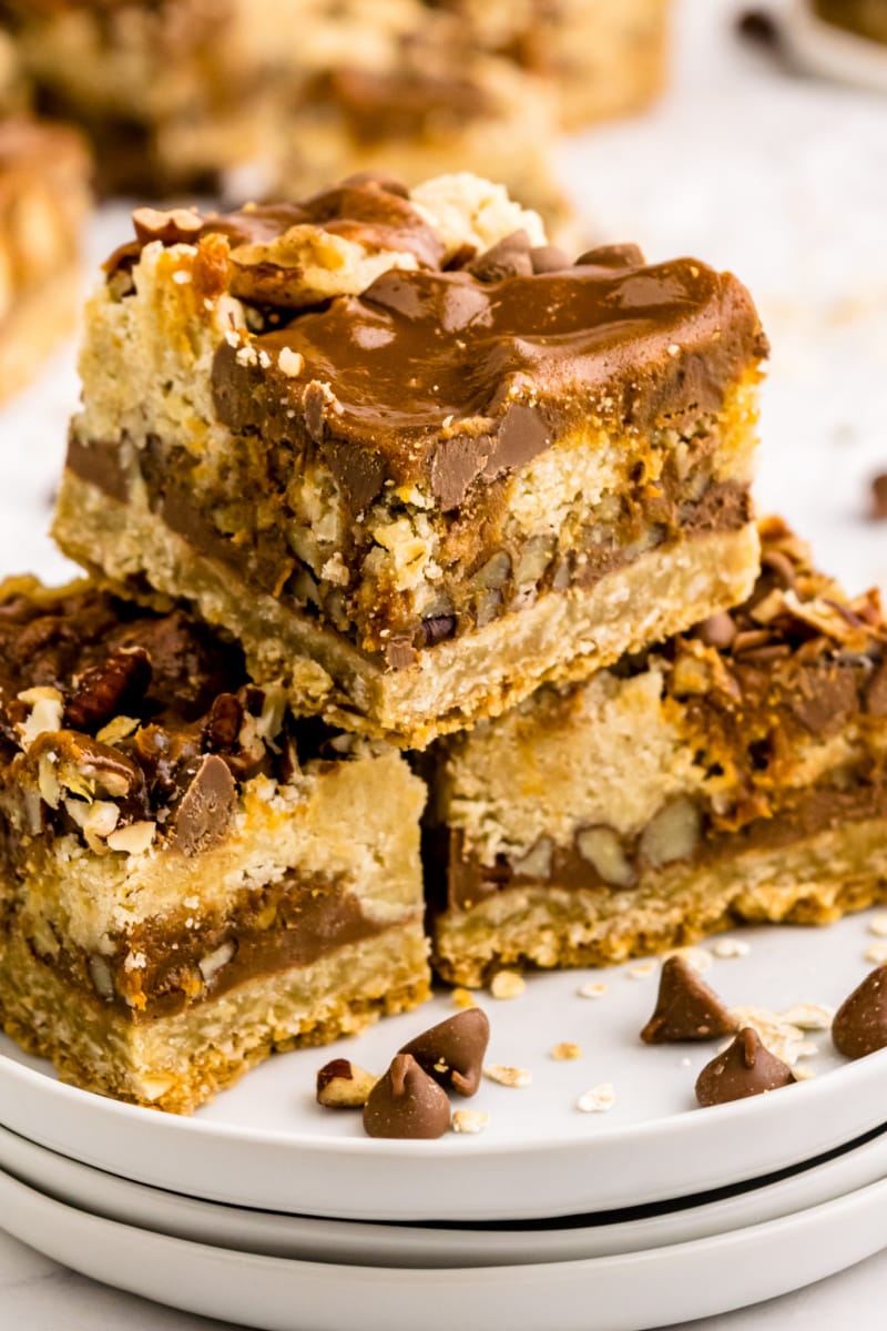 chocolate oatmeal carmelitas stacked on white plate