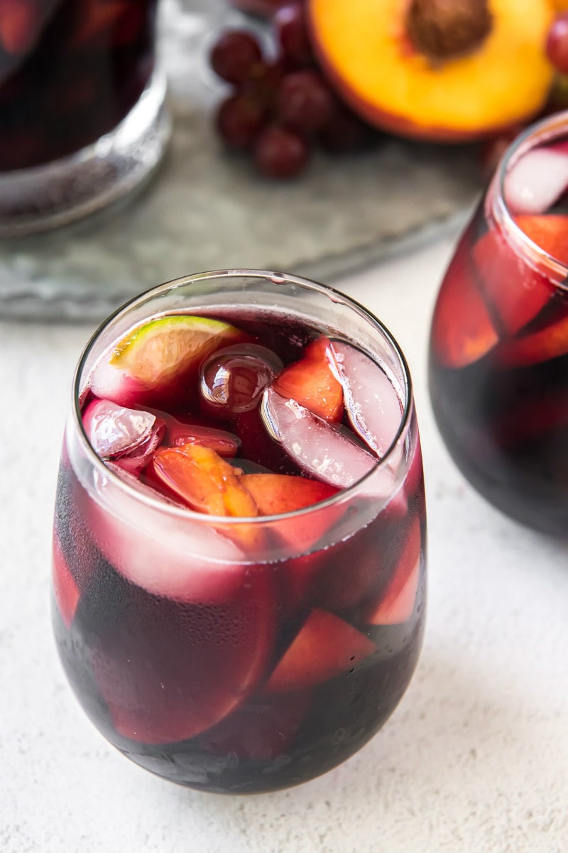 looking overhead into a glass of red wine sangria with peaches