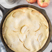 big apple pancake in a cast iron skillet