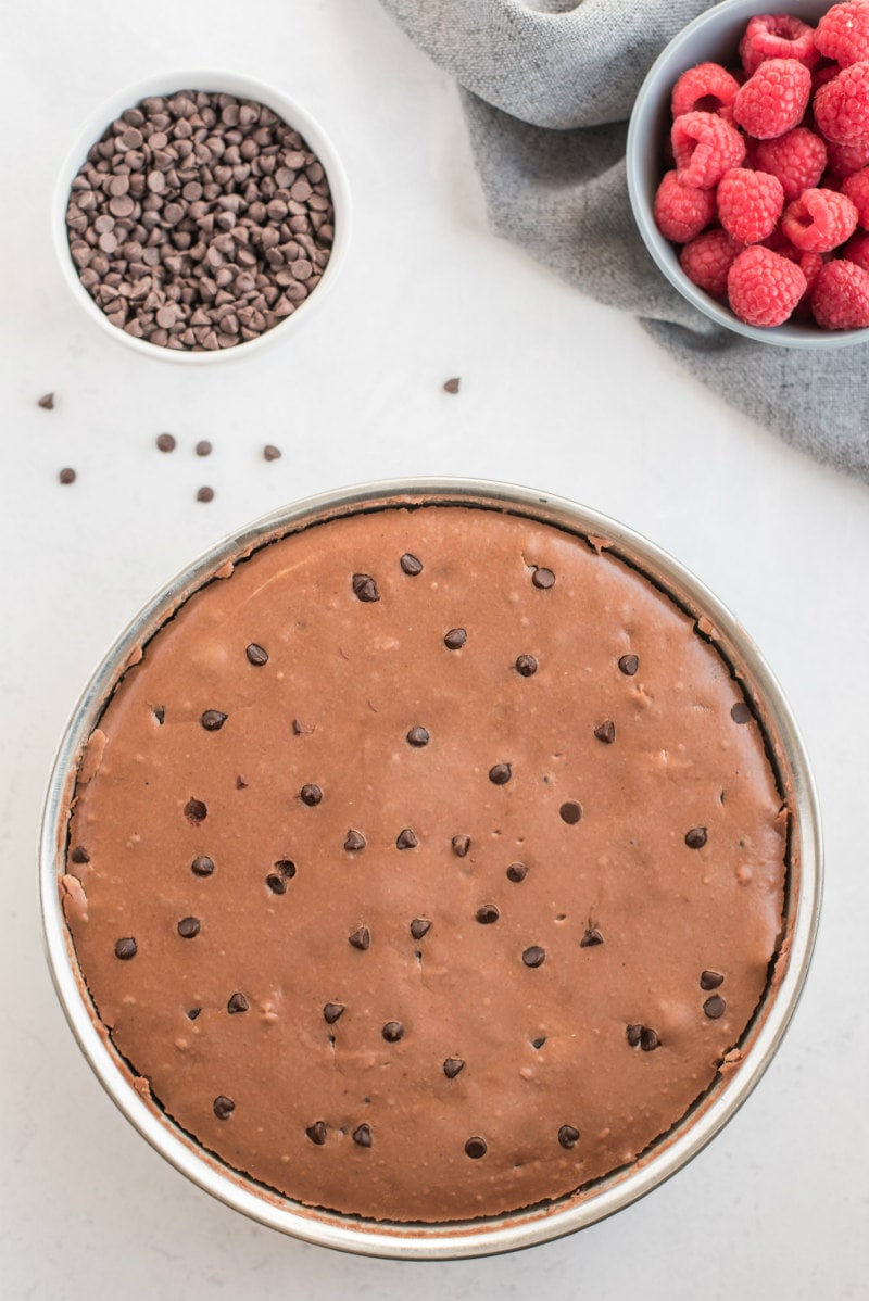 chocolate chocolate chip cheesecake batter in pan just out of oven