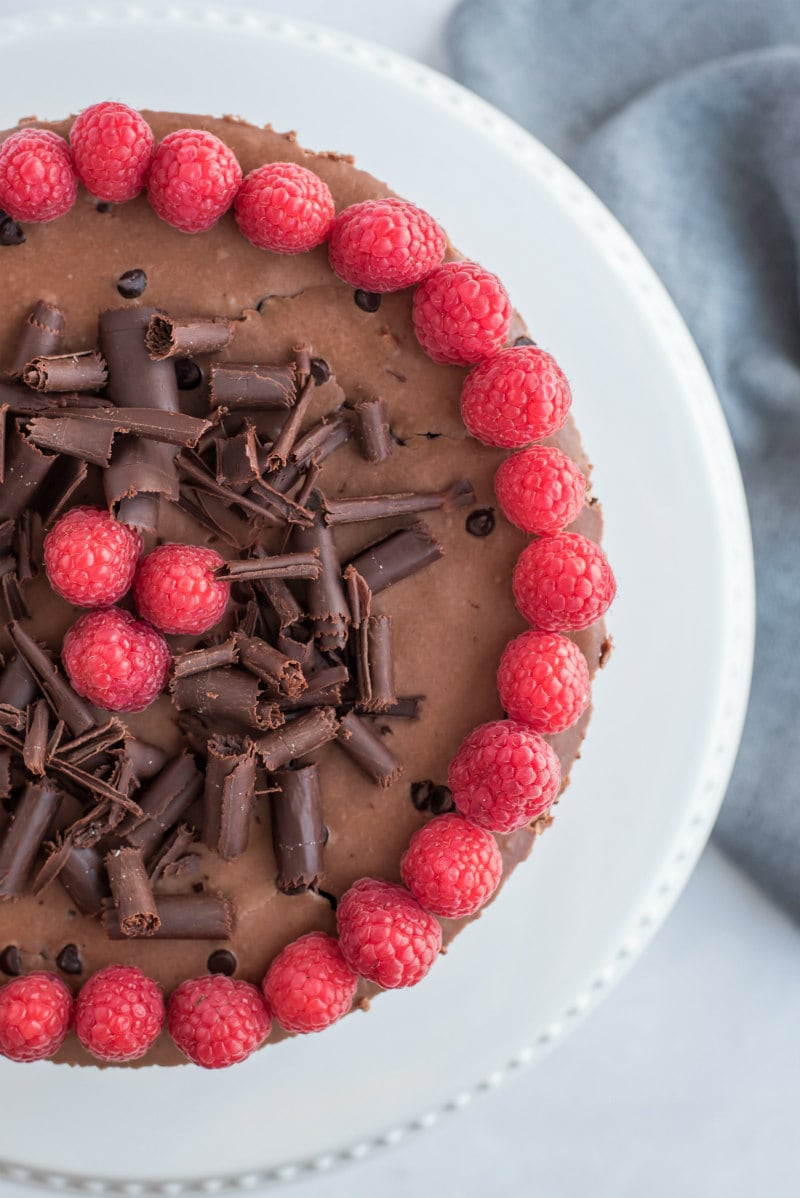 overhead shot of chocolate cheesecake with raspberry garnish