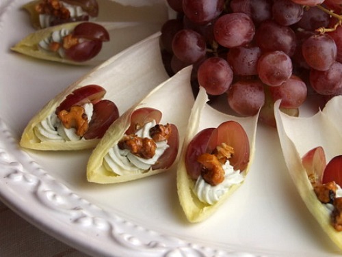Endive with Blue Cheese, Grapes and Candied Walnuts on a platter with grapes