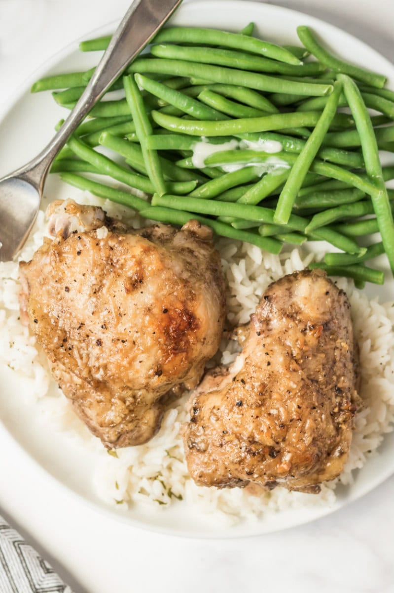 lemon parmesan chicken with rice and green beans on plate
