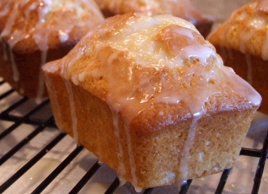 miniature lemon pound cake with glaze on a cooling rack