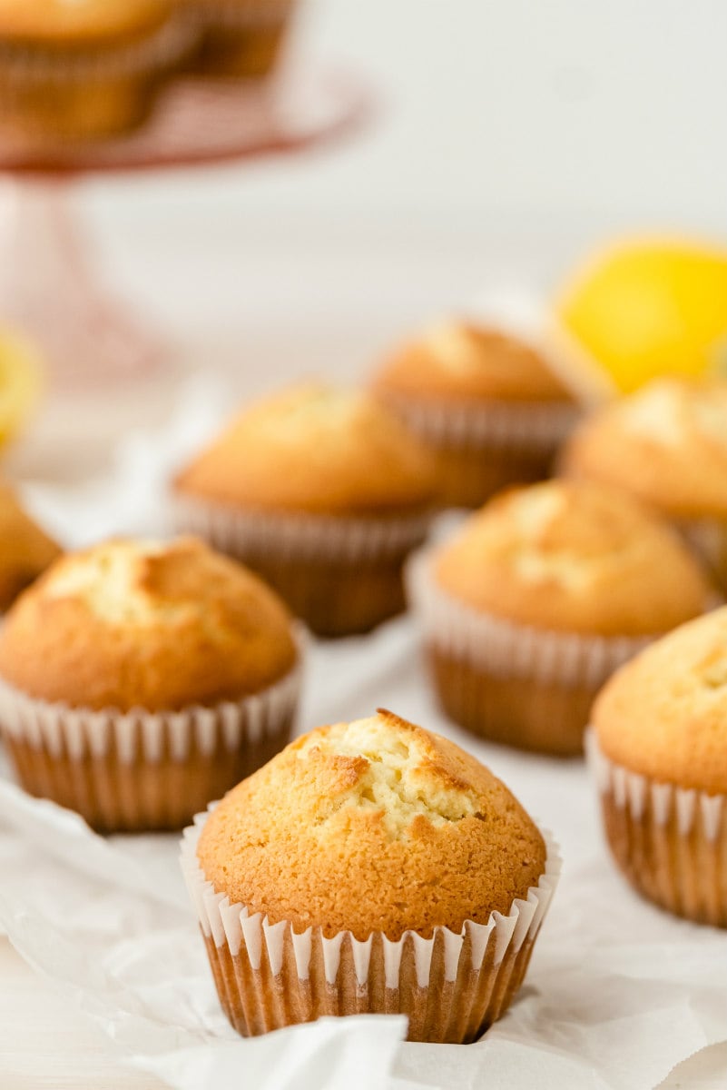 lemon pound cake muffins displayed with a raised display of muffins in the background