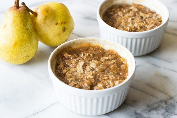 Easy Maple Ginger Pear Crisp in two ramekins with fresh pears