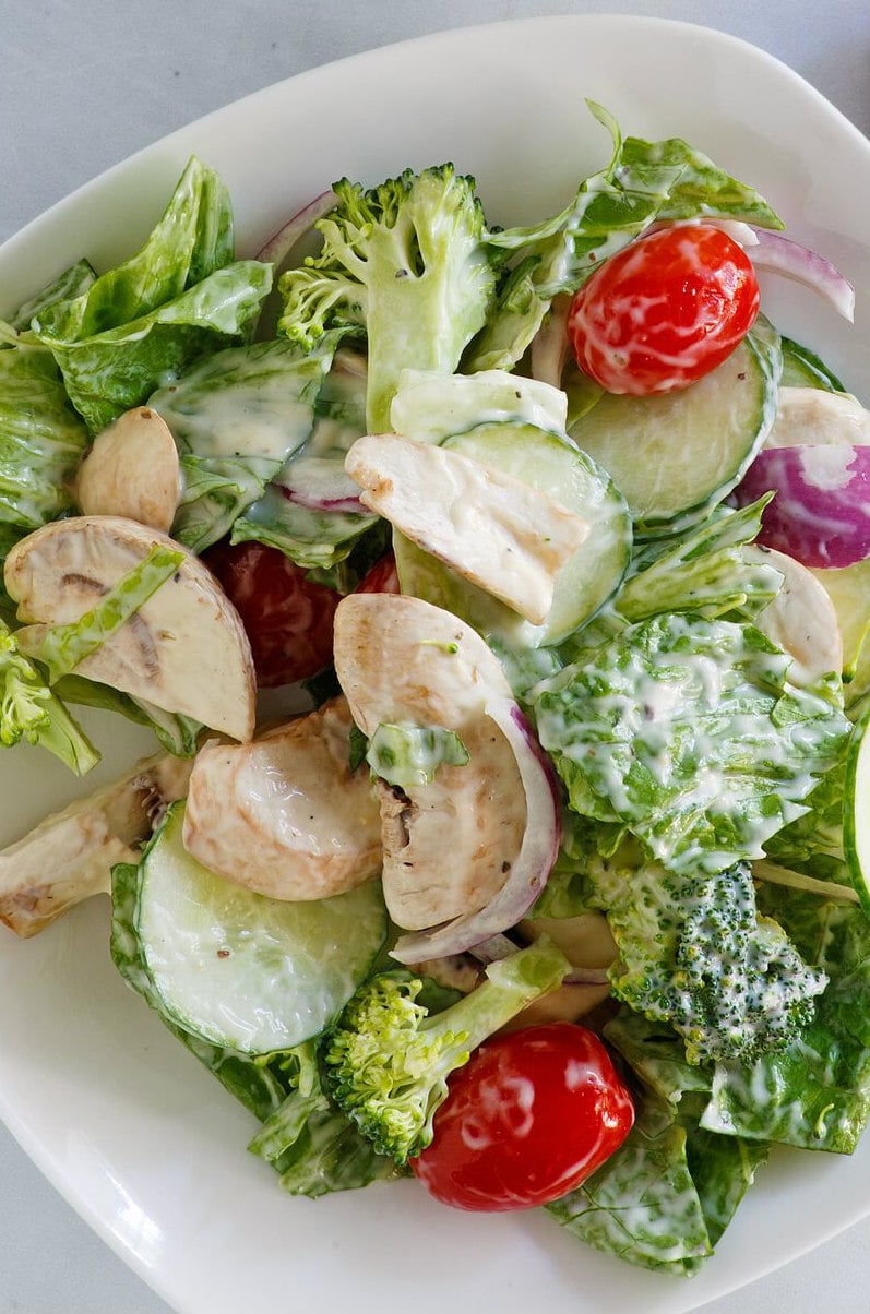 Romaine and Broccoli Salad in a white bowl