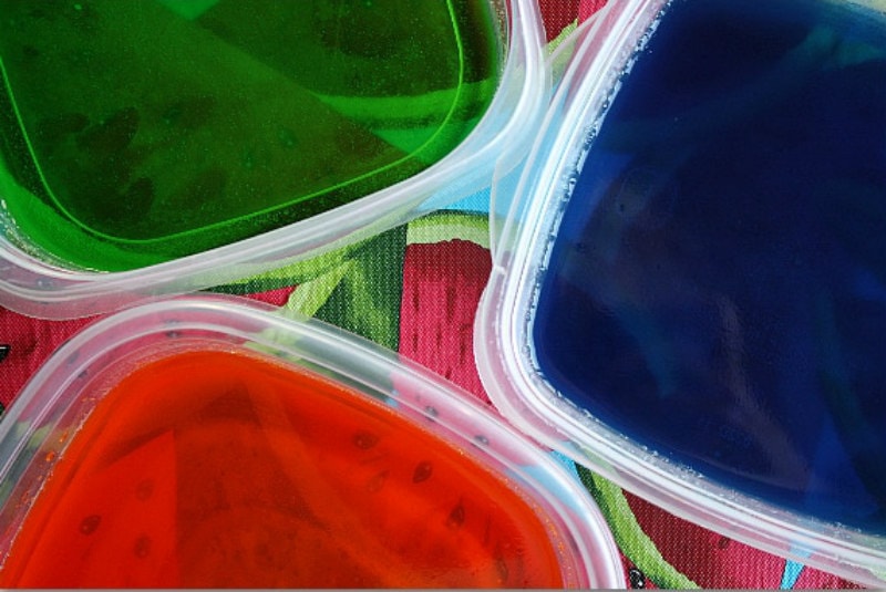 three plastic tubs of jello - green, blue and red