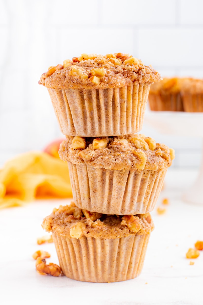 three sweet peach muffins stacked