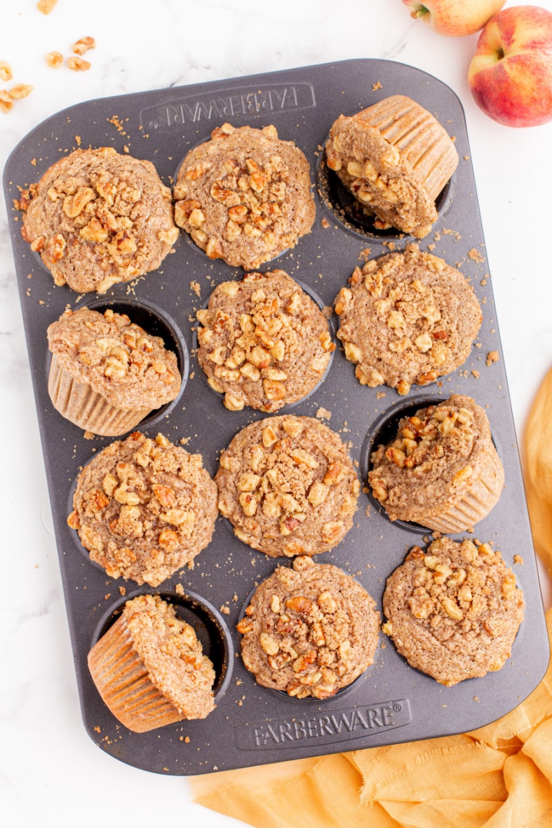 sweet peach muffins in a muffin pan