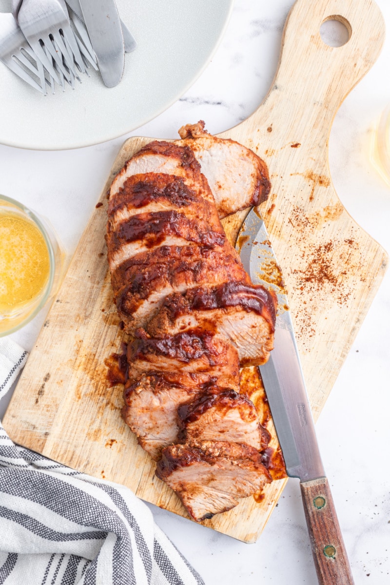 sweet and tangy roasted pork tenderloin sliced on board