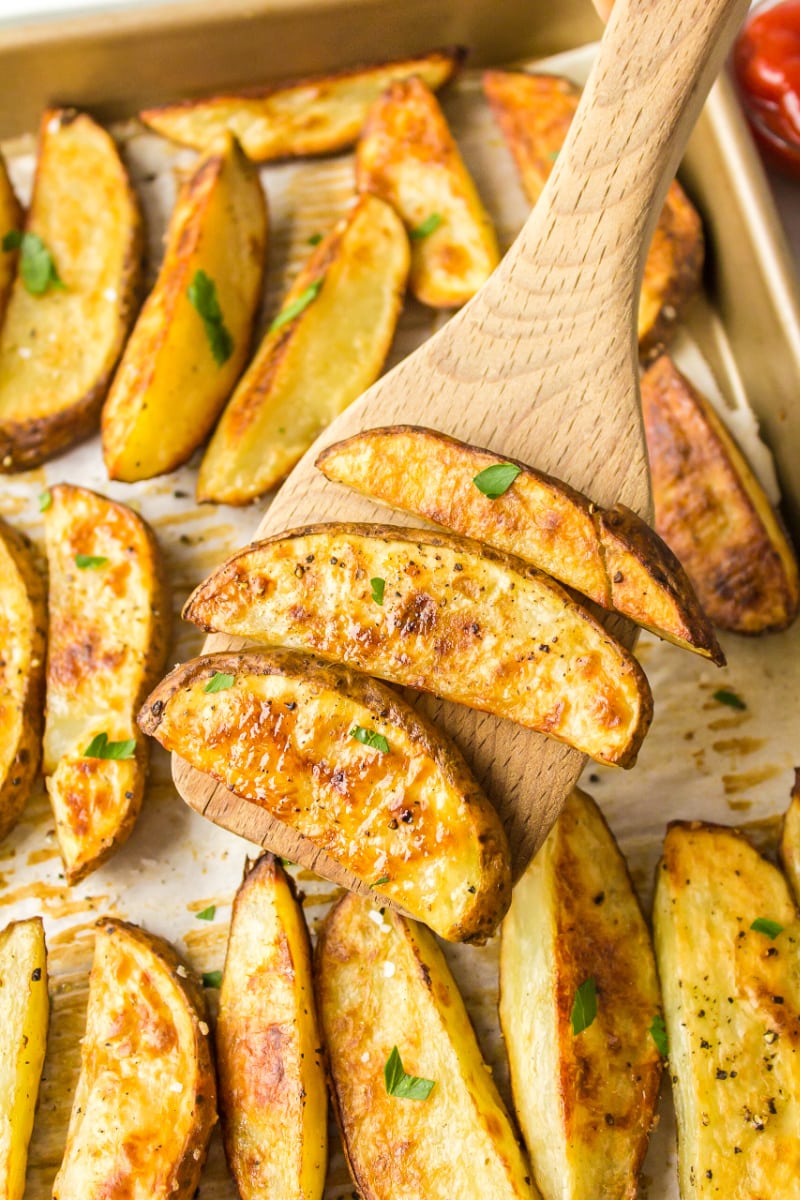 spatula scooping up oven roasted fries