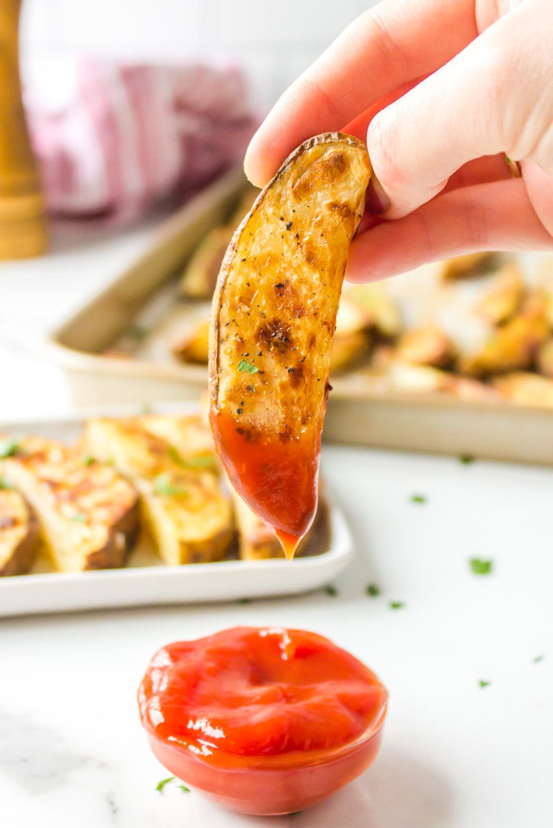 dipping a fry into ketchup