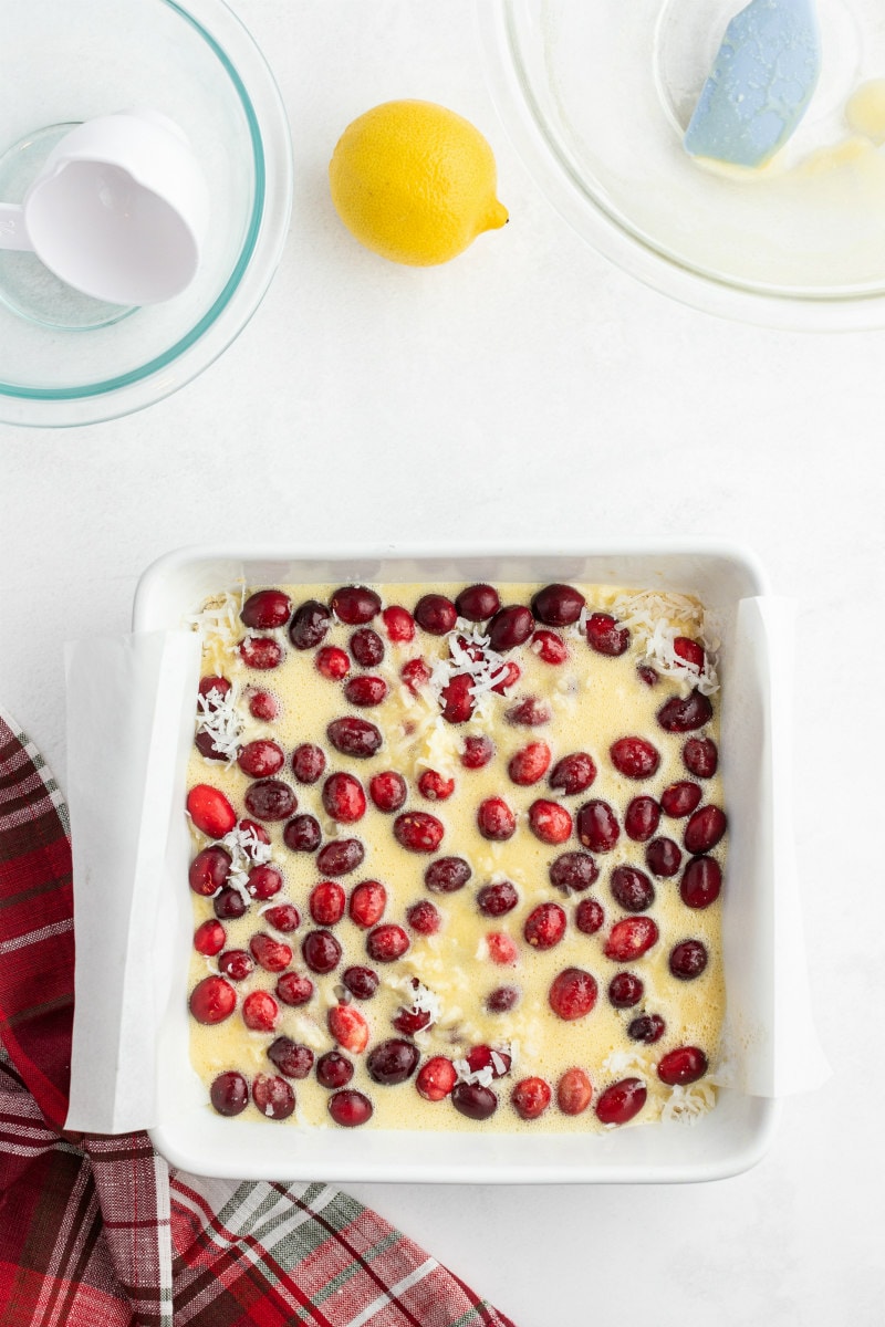 process of making cranberry coconut squares= filling in pan