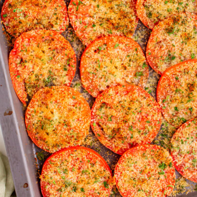 Tomatoes with Asiago on a baking sheet