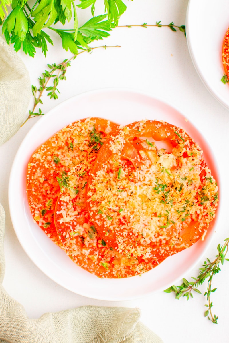 sliced tomatoes with asiago on white plate