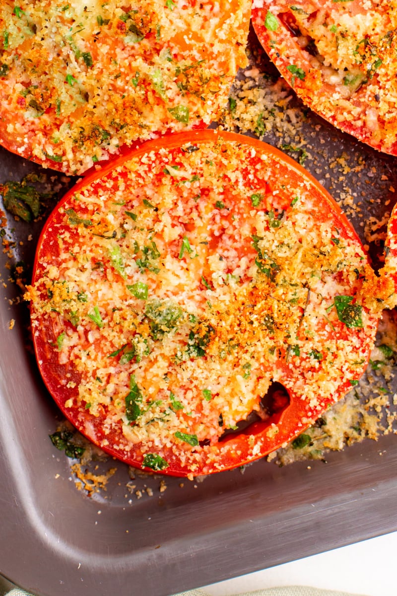 tomato with asiago cheese on baking sheet