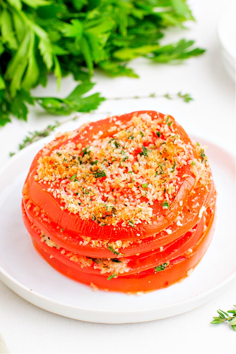 stacked tomatoes with asiago on a plate