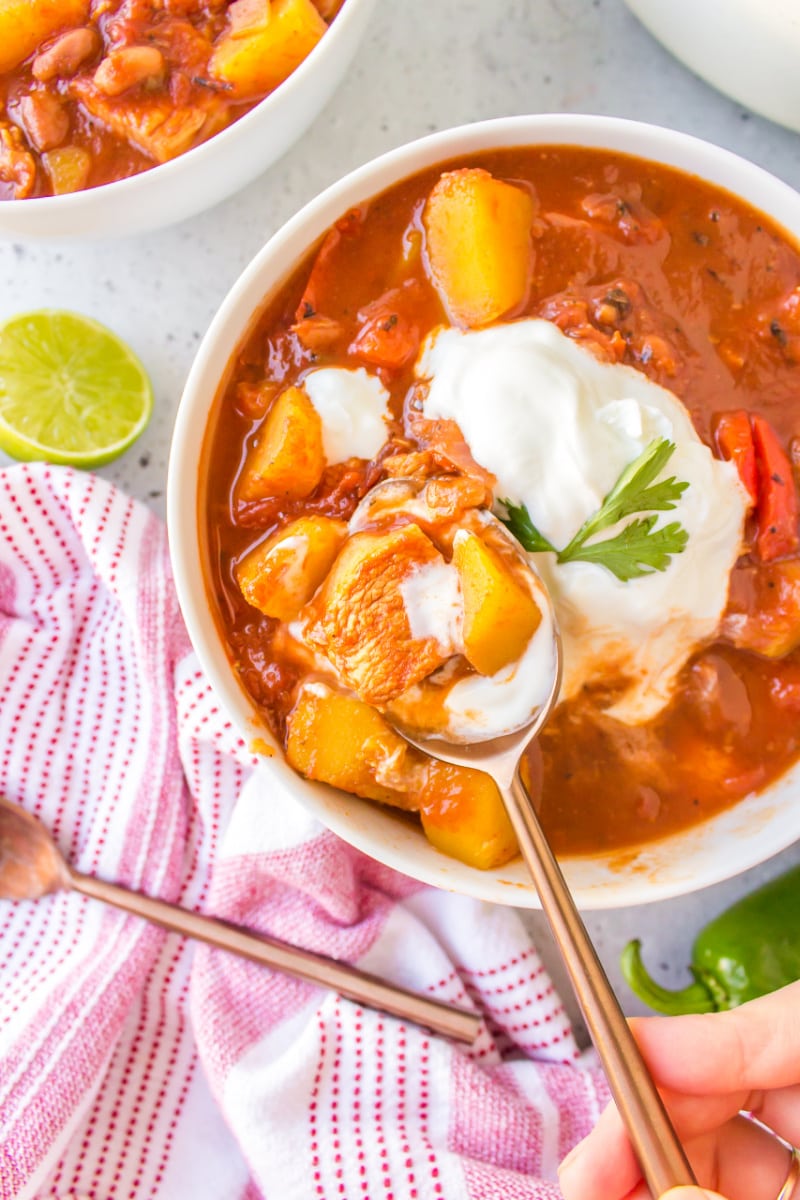 spooning acorn squash and chicken chili out of bowl