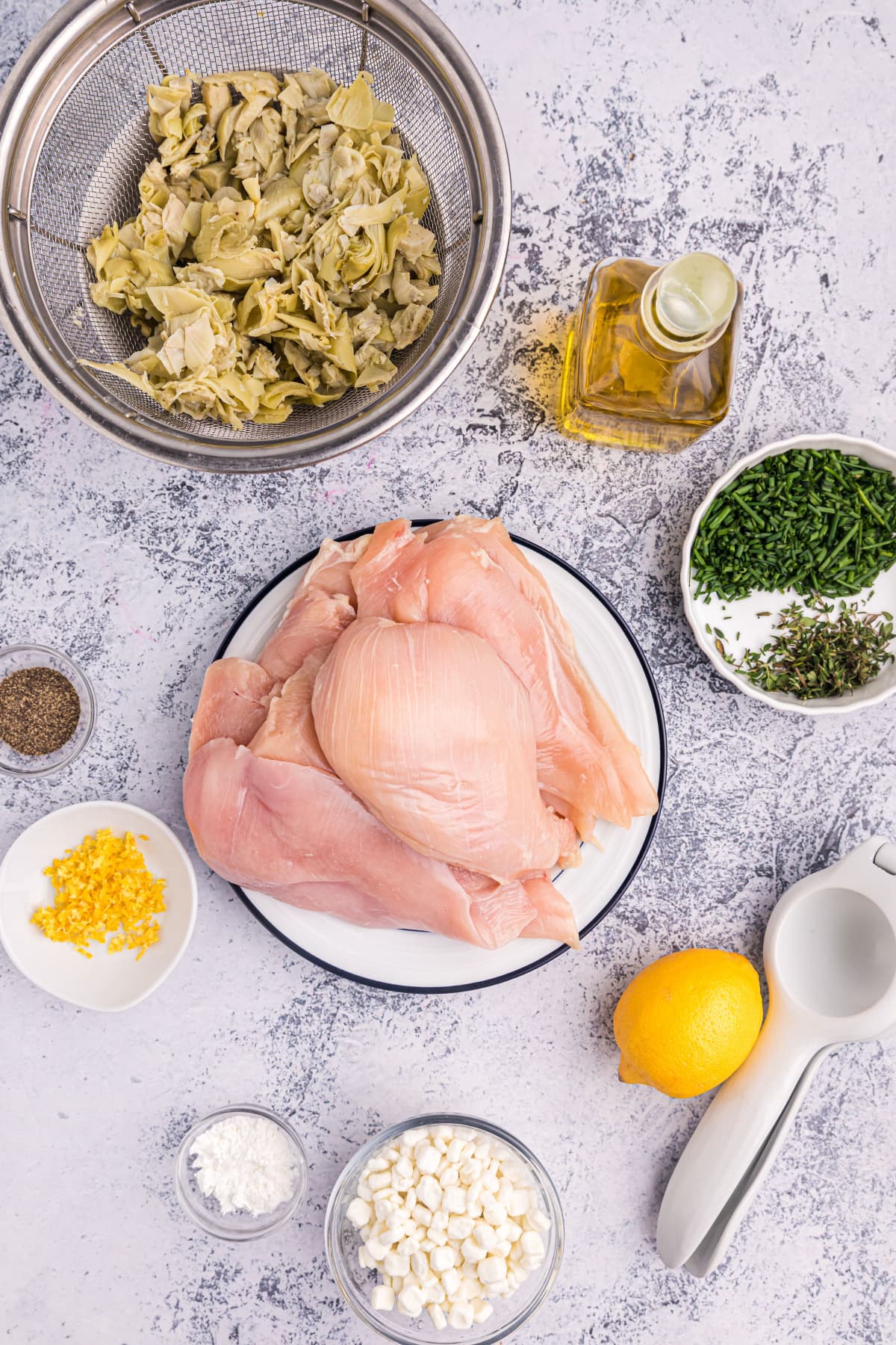 ingredients displayed for making artichoke and goat cheese stuffed chicken