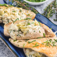 Artichoke and goat cheese stuffed chicken on platter