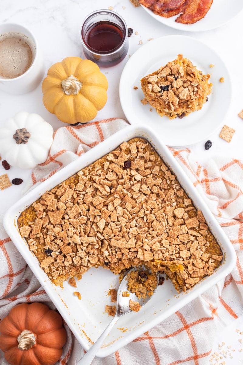 pan of baked pumpkin pie oatmeal with piece scooped out