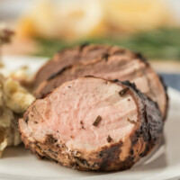 sliced grilled pork tenderloin on a white plate