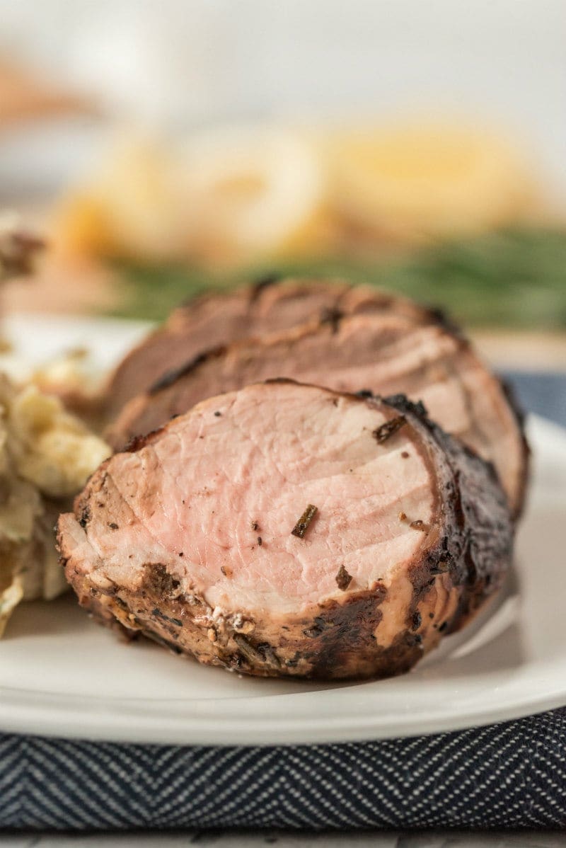 sliced grilled pork tenderloin on a white plate