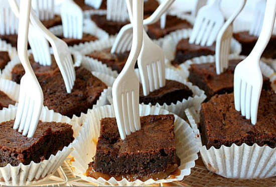 Fudgy Caramel Brownies in papers with forks