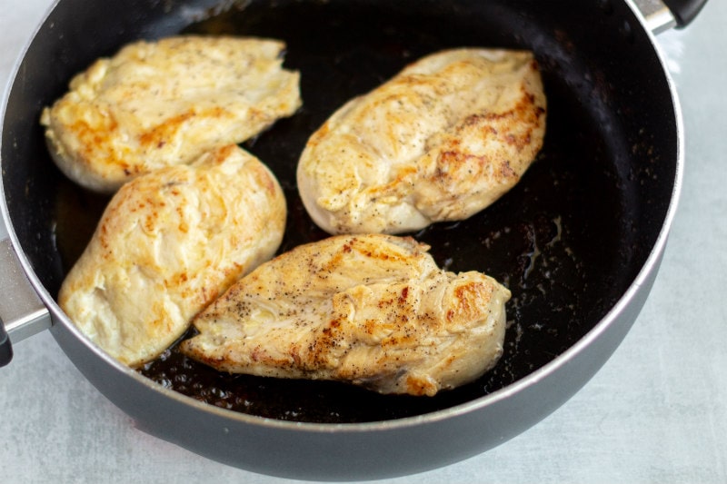 Chicken cooking in a skillet