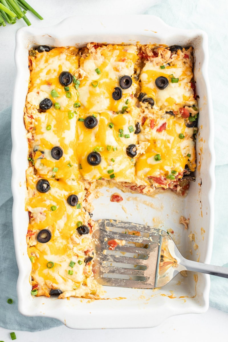 Chicken Enchilada Casserole recipe from RecipeGirl.com #chicken #enchilada #casserole #recipe #RecipeGirl spatula serving chicken enchilada casserole