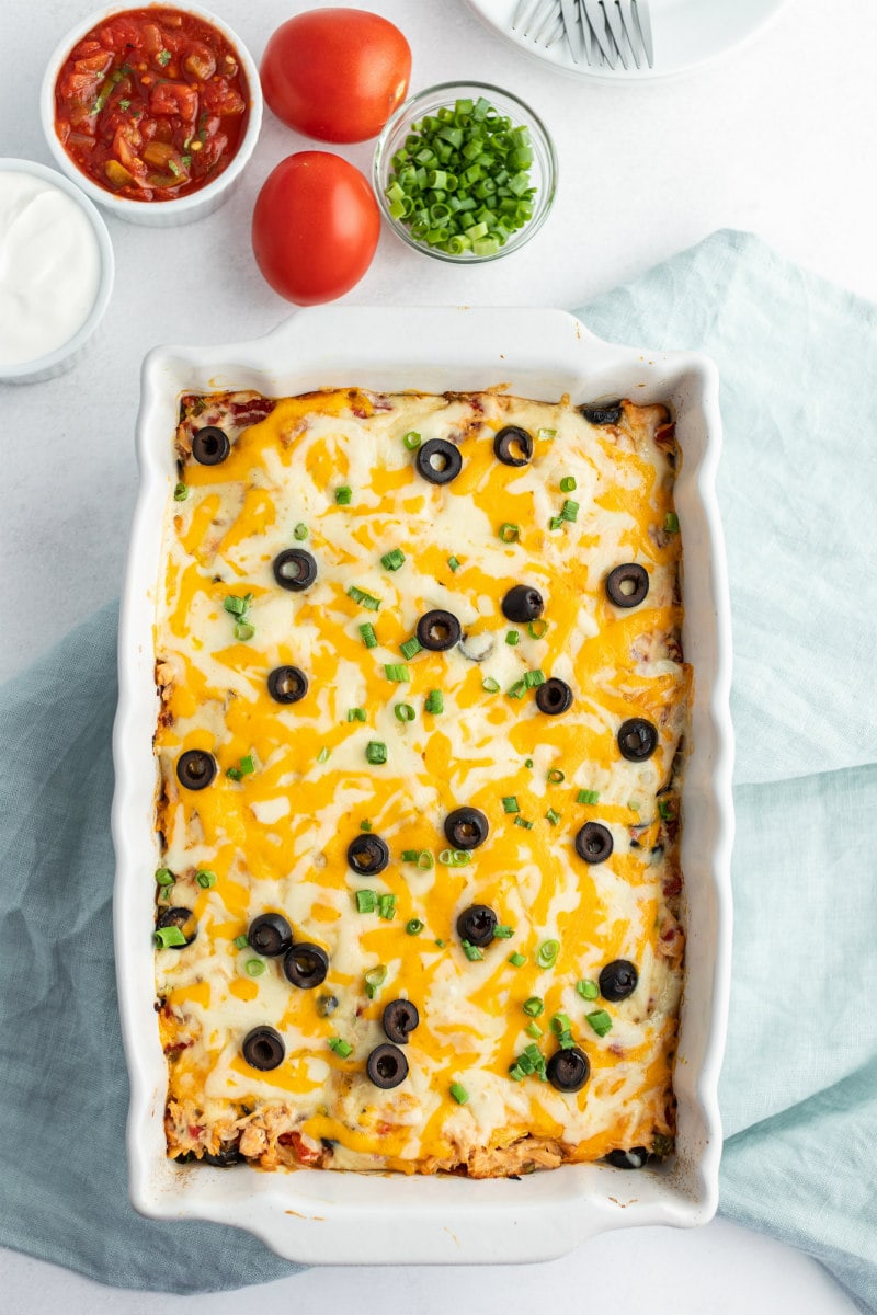 Chicken Enchilada Casserole recipe from RecipeGirl.com #chicken #enchilada #casserole #recipe #RecipeGirl chicken enchilada casserole in white dish