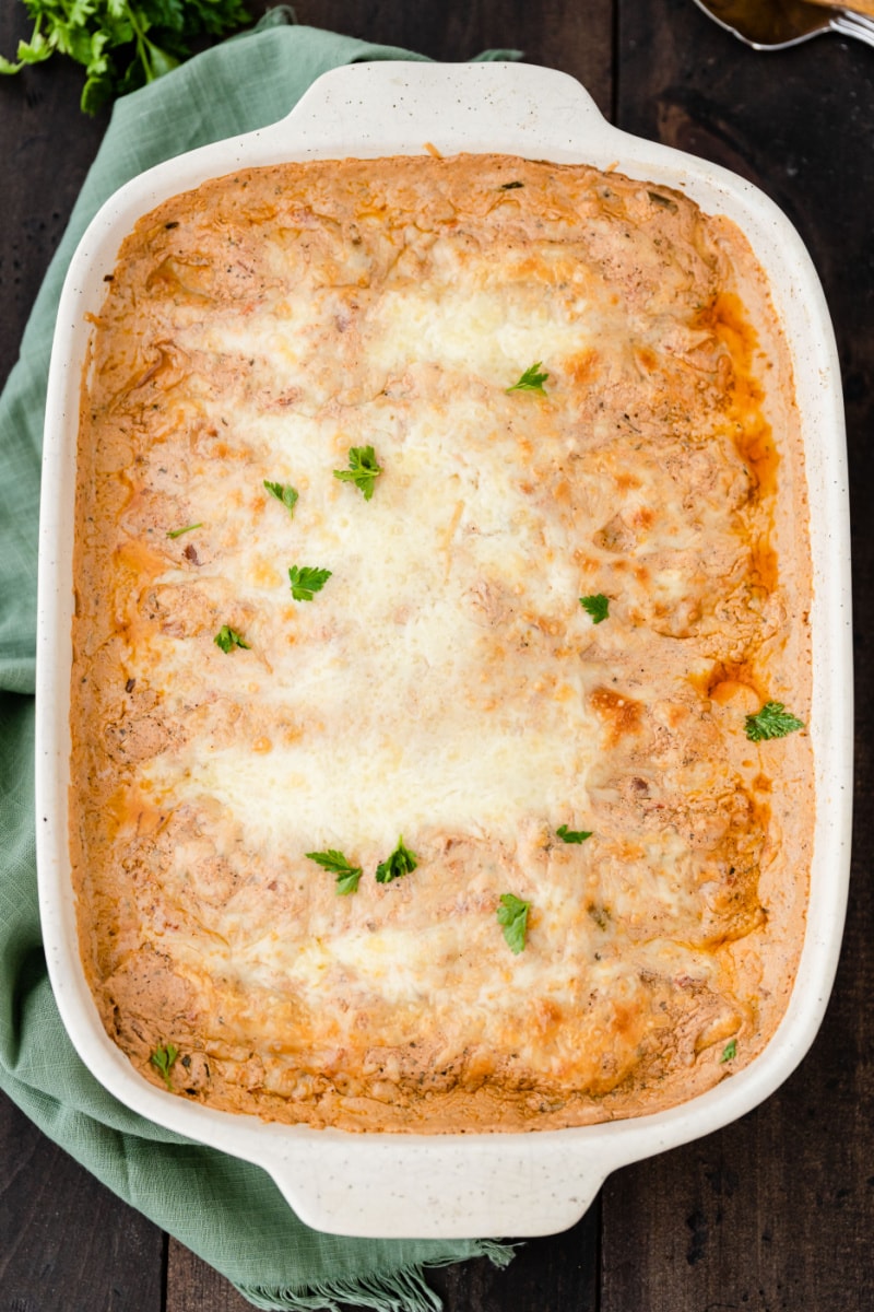 creamy chicken enchiladas in white casserole dish