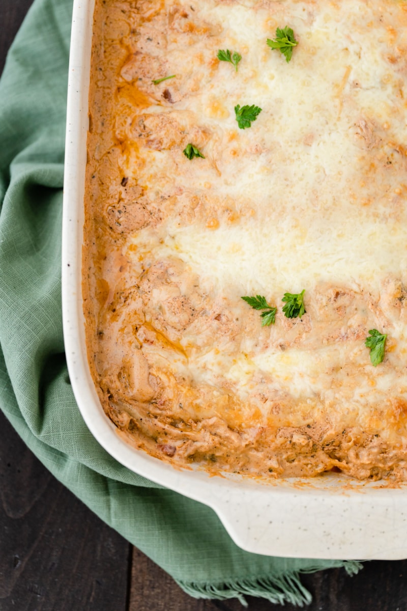 creamy chicken enchiladas in white casserole dish