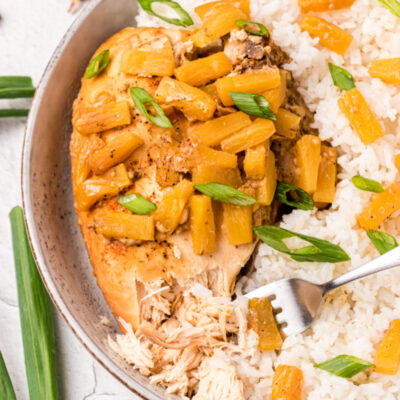 crockpot pineapple chicken on plate with rice