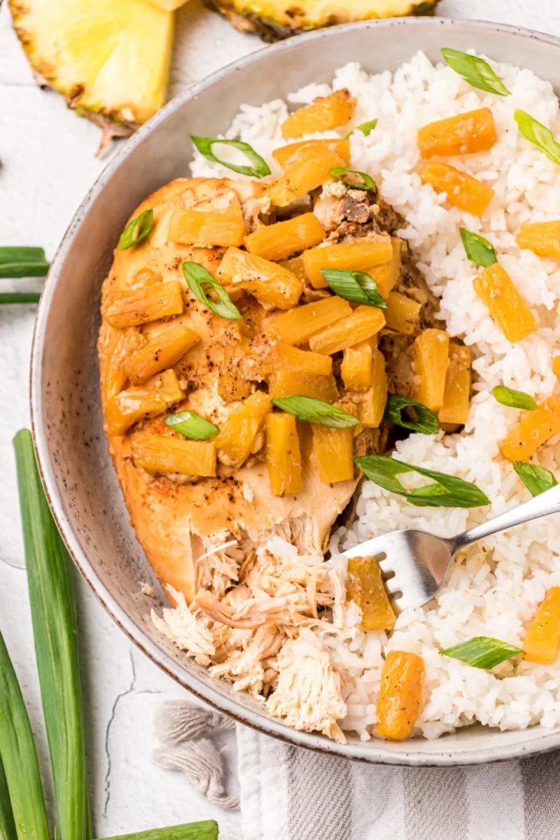 crockpot pineapple chicken on plate with rice